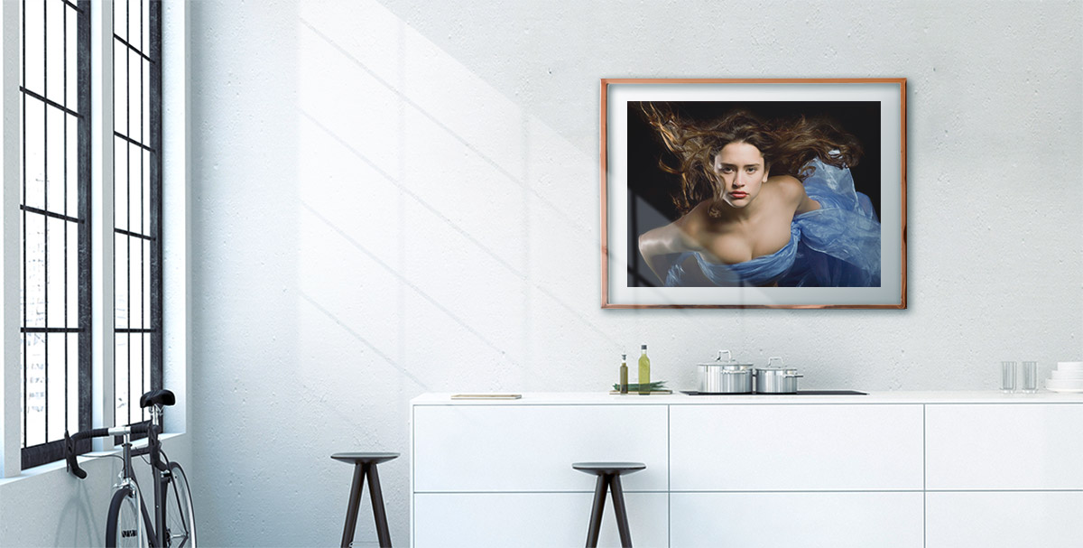 fine art print in bronze frame hanging in a room