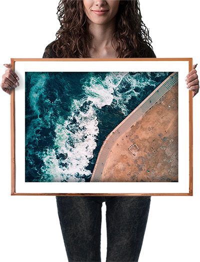 giclee print in frame held by woman